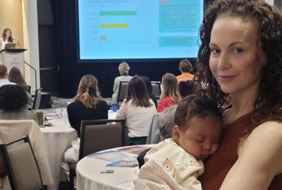 Women holding baby at THMA professional development symposium